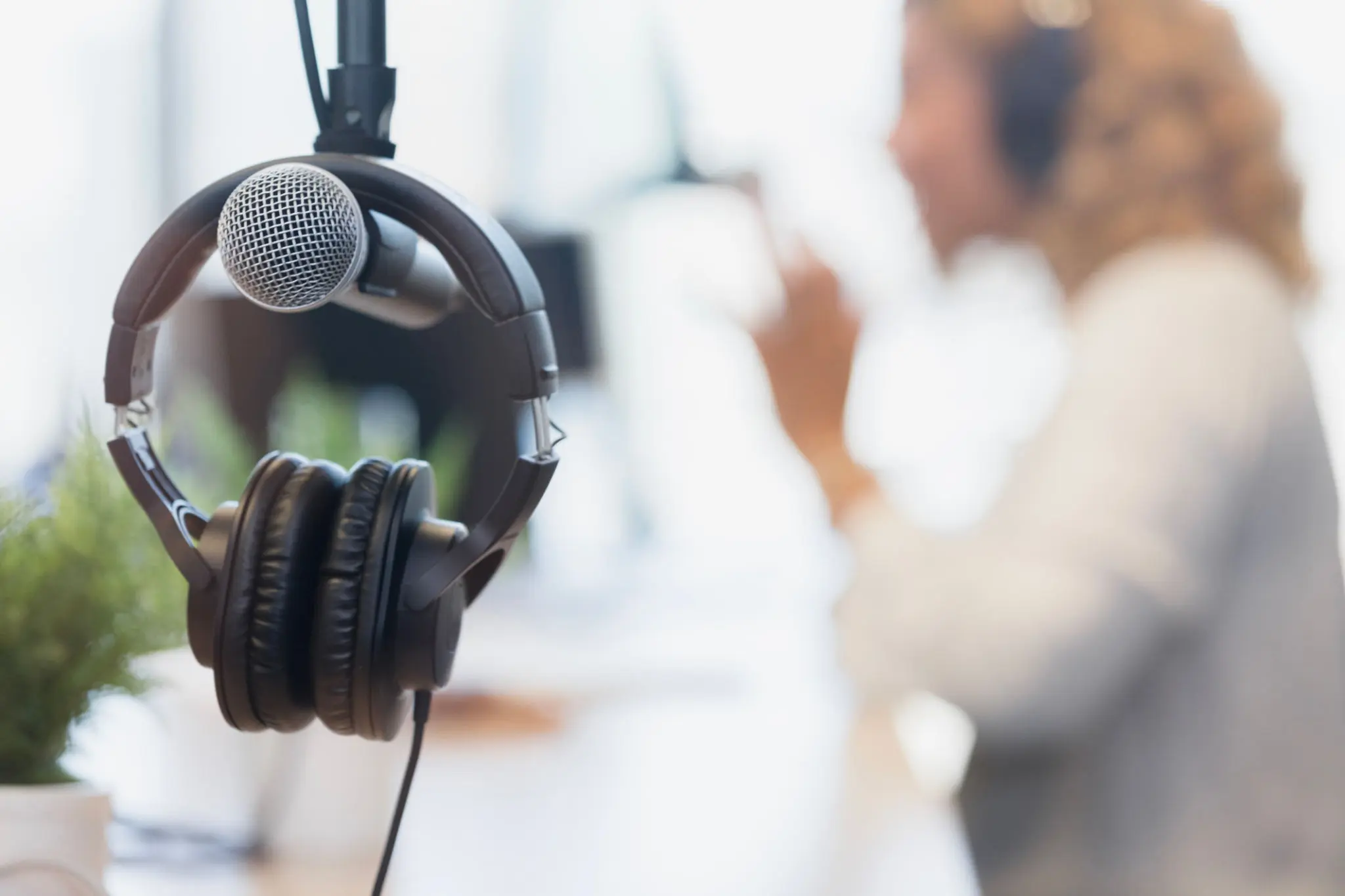 Microphone and headphones with blurred background.